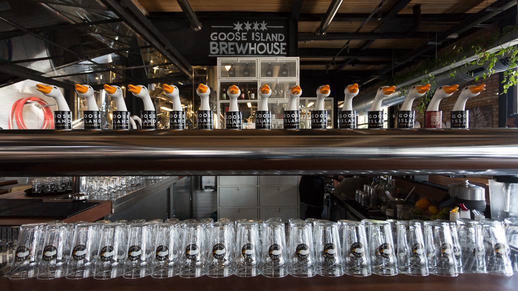 Torneiras e copos de chopp na brewhouse da Goose Island em SP